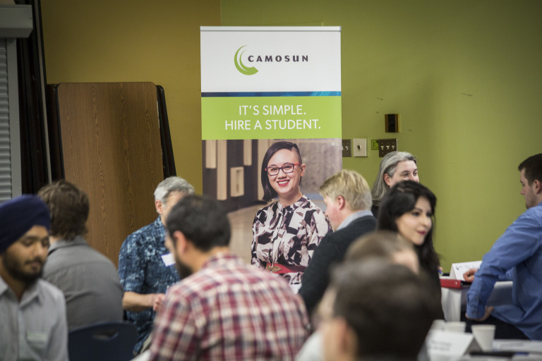 students and potential employers meet at a networking breakfast